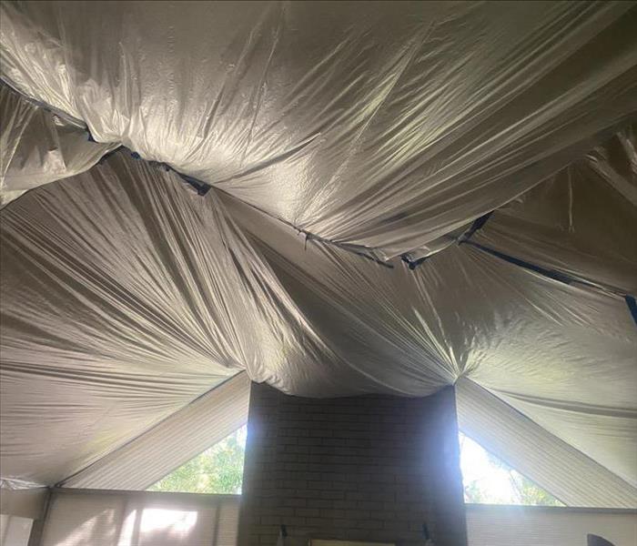 Ceiling covered with plastic during roof repair