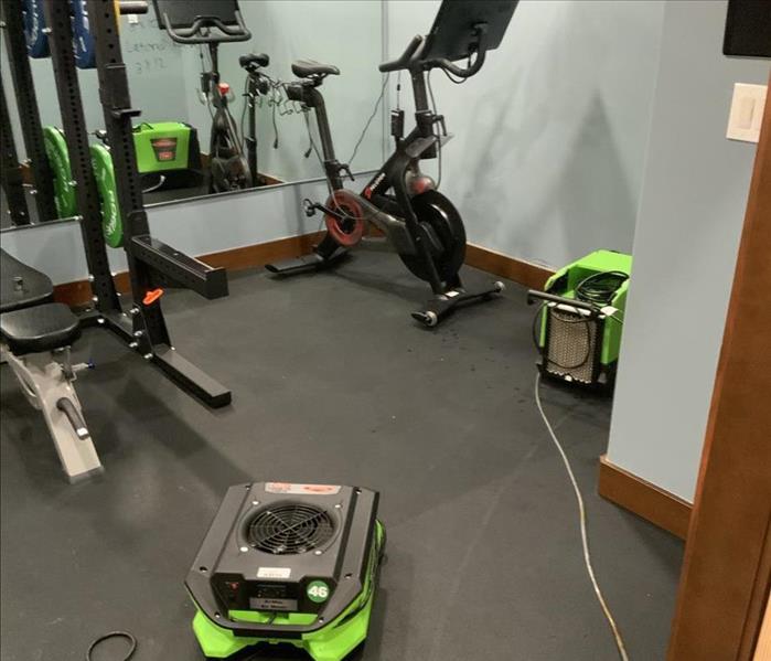 Drying equipment set up at a home gym affected by water loss