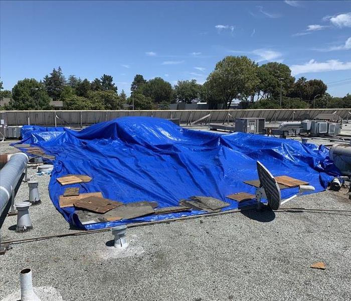 Blue tarp on a roof of a commercial building